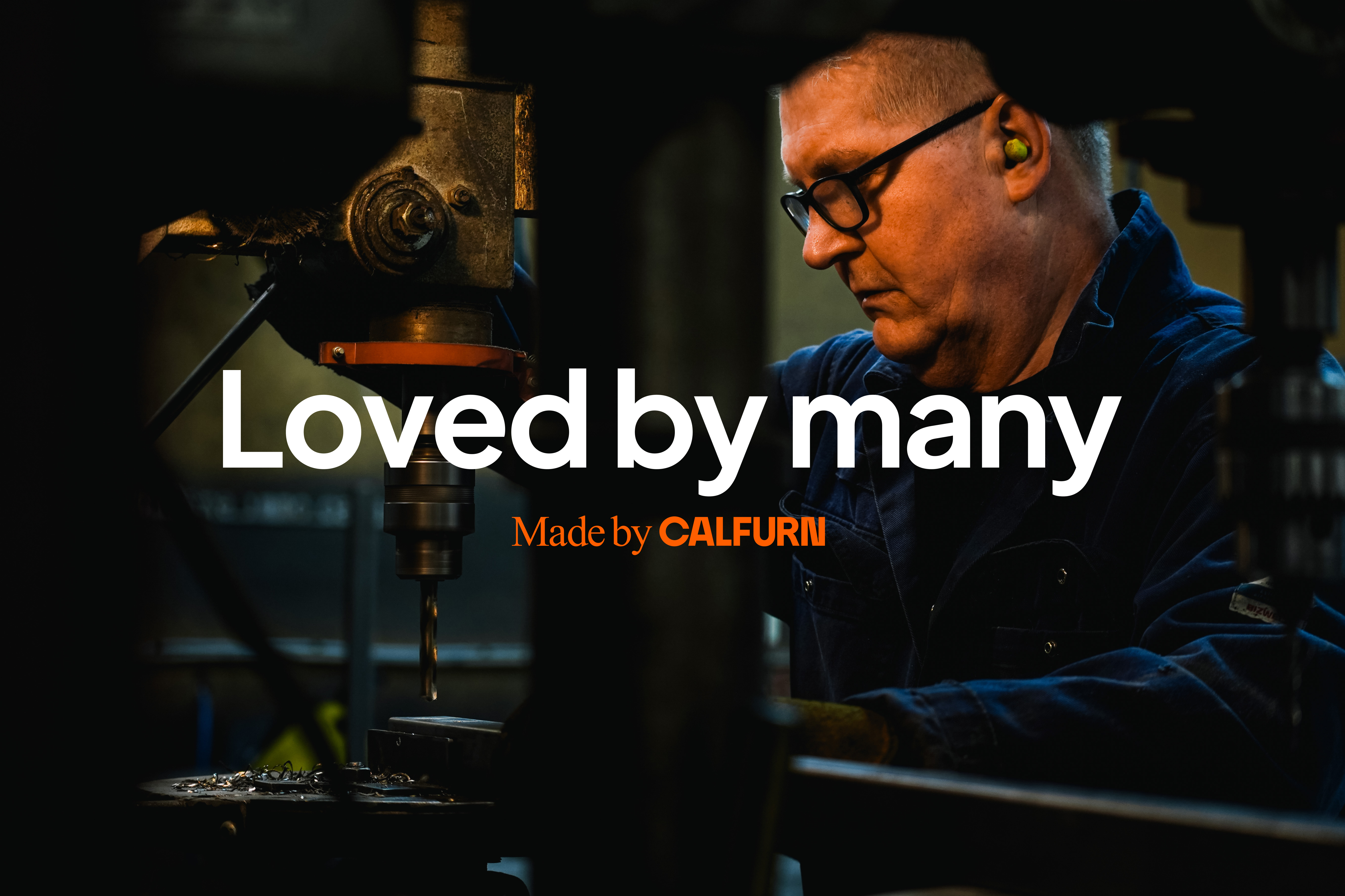 Calfurn craftsperson operating machinery in the factory with the slogan "Loved by many" and "Made by Calfurn"