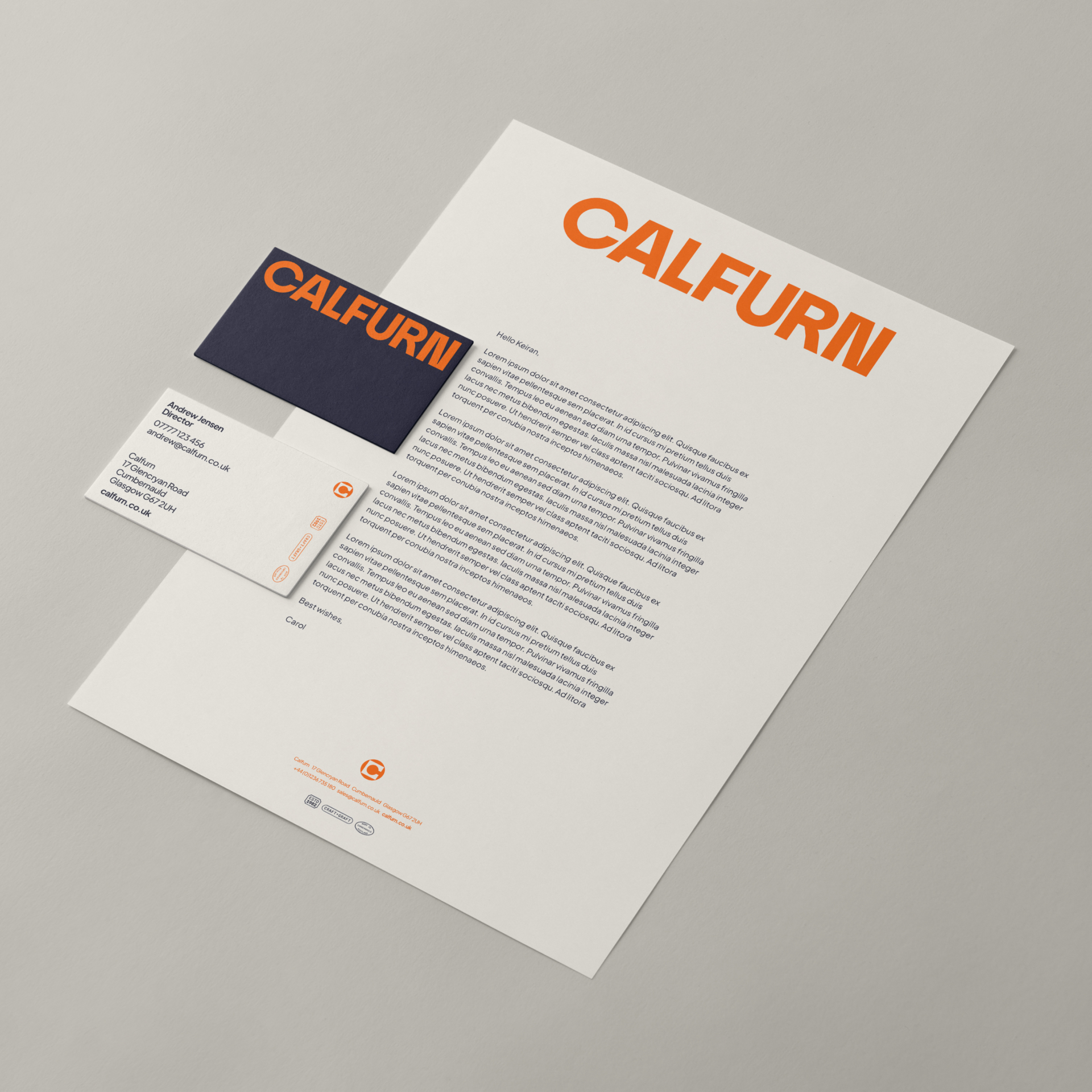 A Calfurn branded letterhead laid down on a desk, with Calfurn business cards laid on top