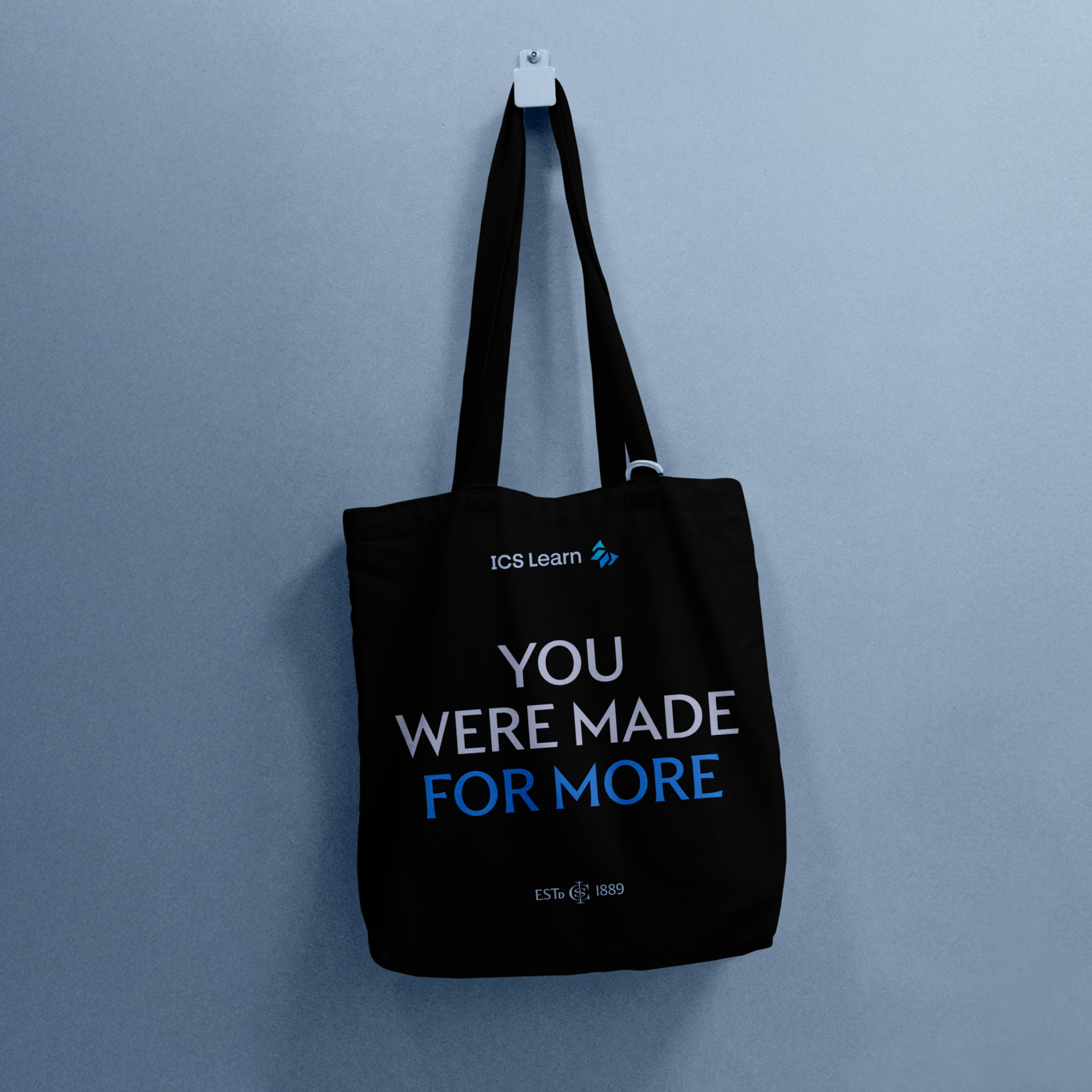 A navy coloured ICS Learn tote bag with the words 'You were made for more'