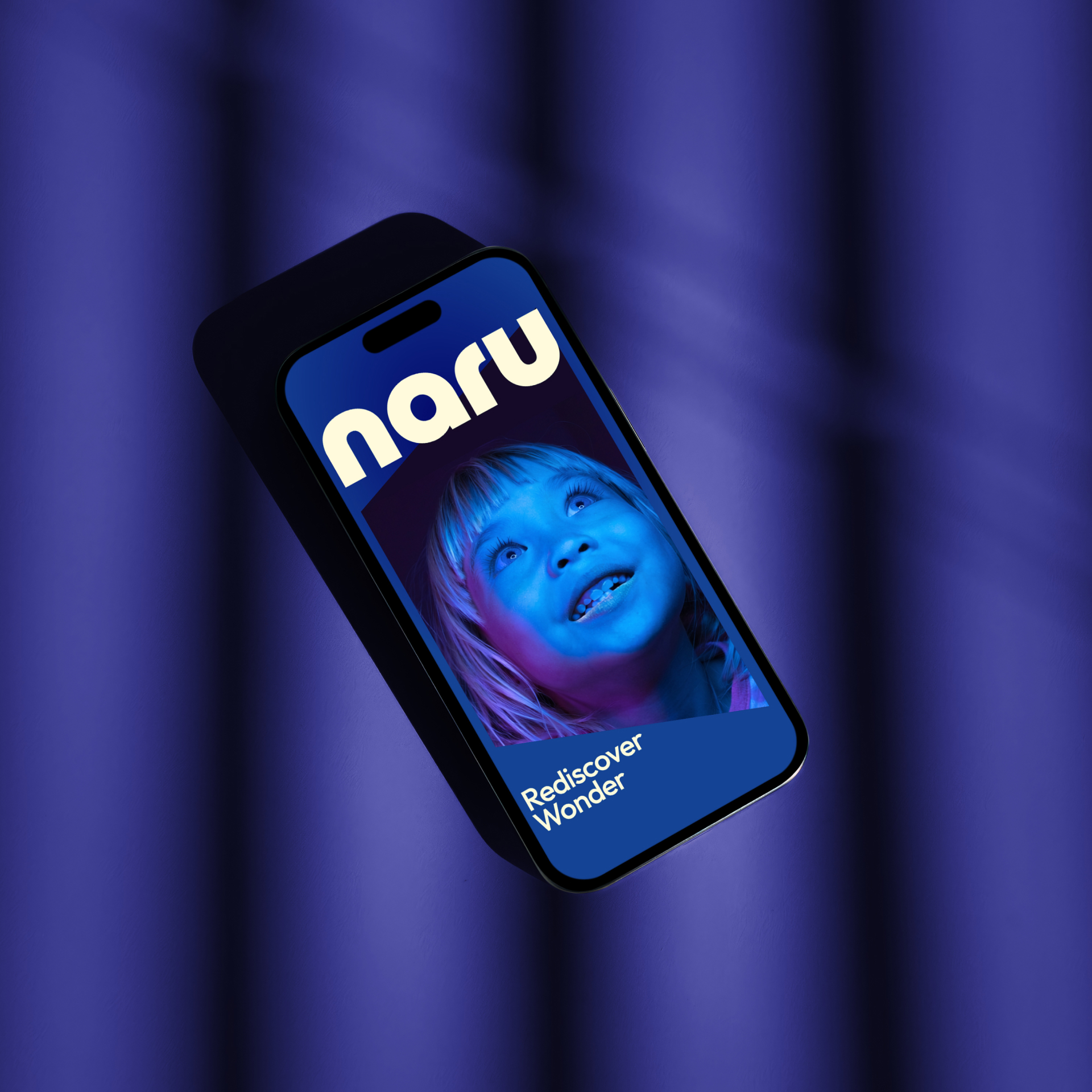 A mobile phone showing an image of a young girl alongside the Naru logo and a tagline 'Rediscover Wonder'