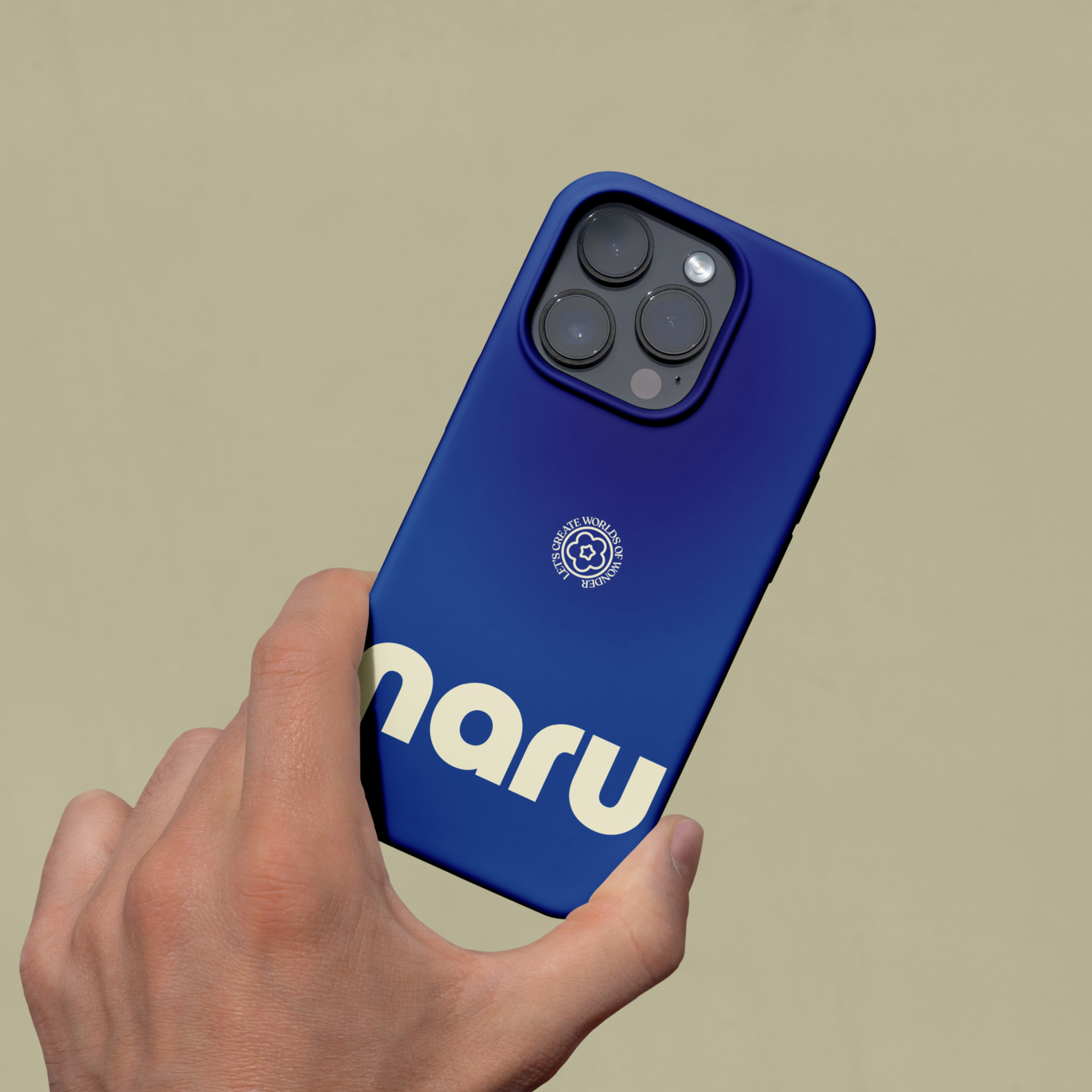 The back of a mobile phone being held, which has a Naru branded phone case on it