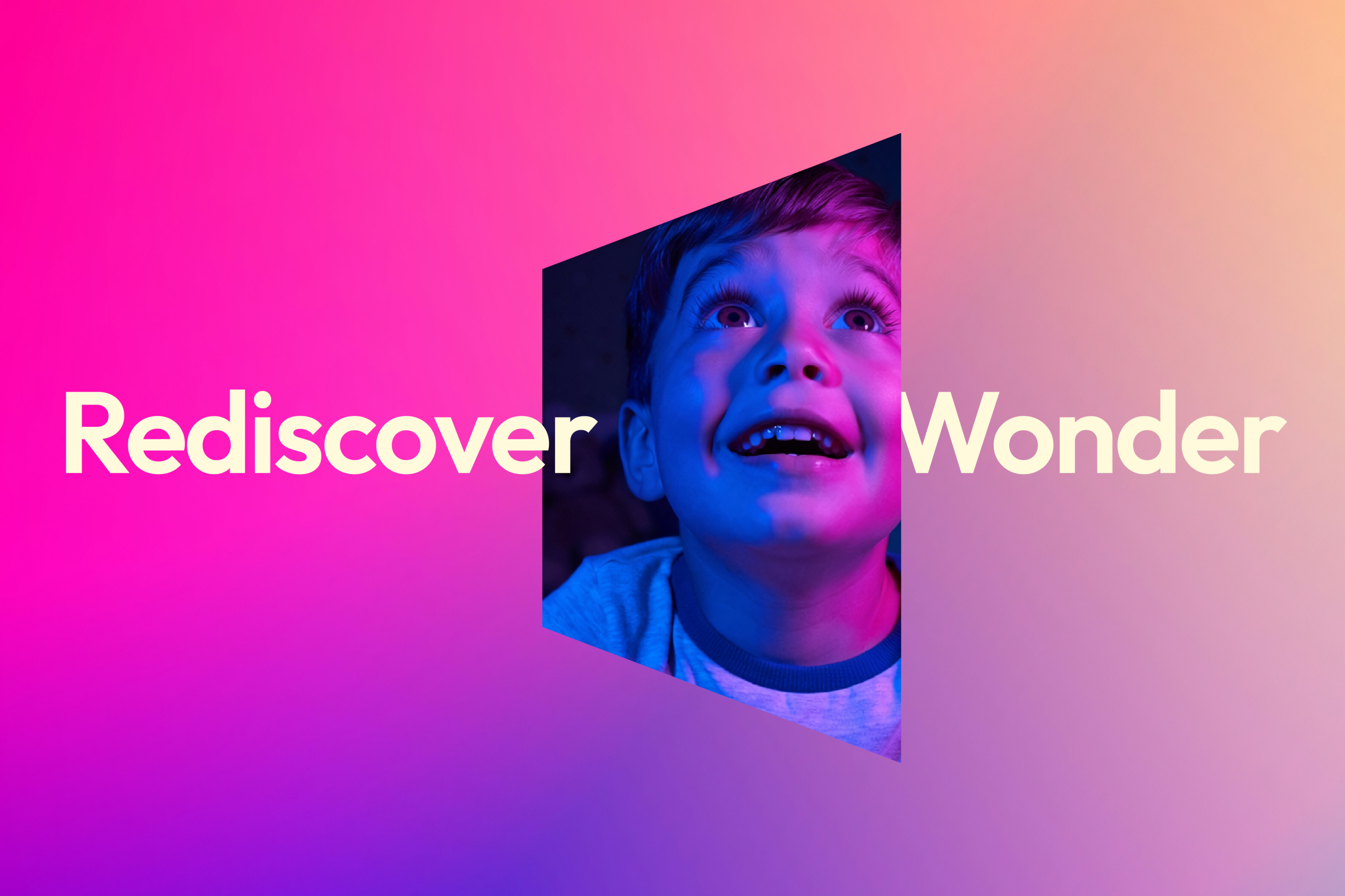 A young boy with an expression of awe, with the words 'Rediscover Wonder' either side of him