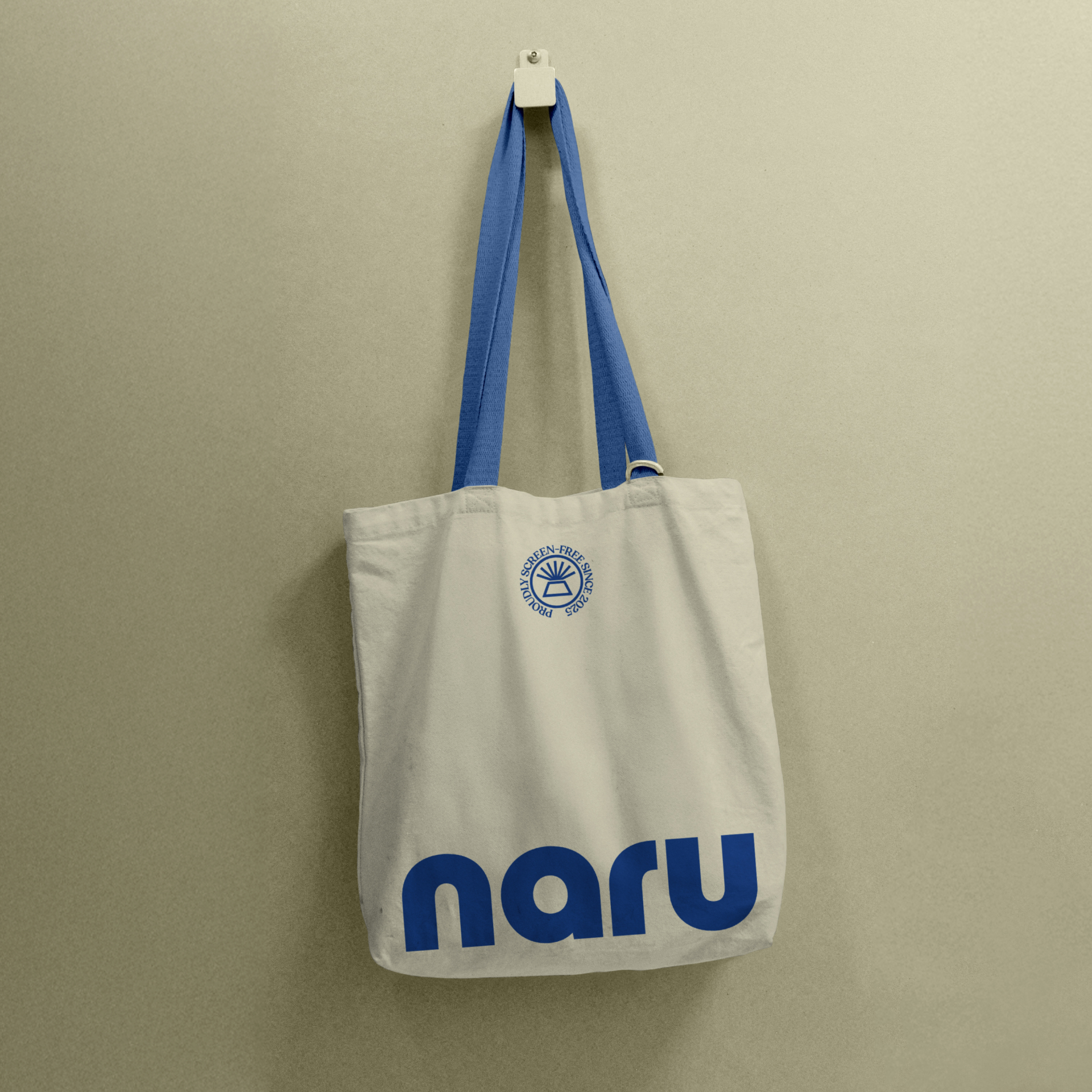 A Naru branded tote bag hanging up on a wall
